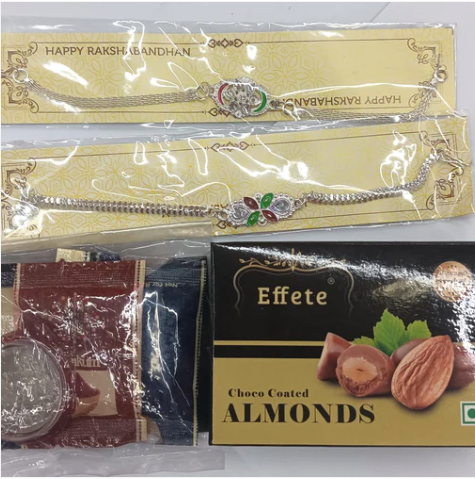 Raksha Bandhan Gift Combo – 2 Stylish Rakhis with Silver Coin, Chocolates & Pooja Kit