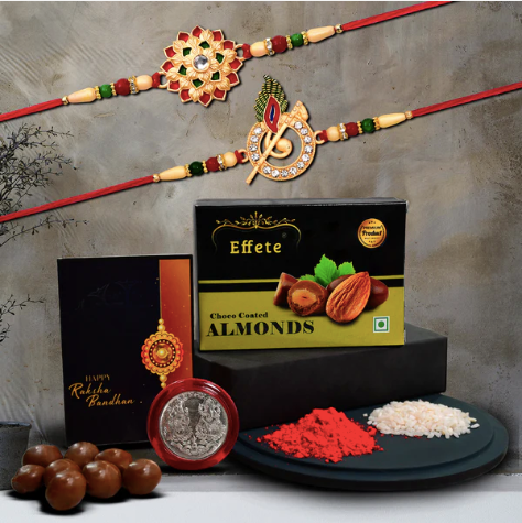 Traditional Rakhi Combo – 2 Designer Rakhis with Choco Almonds, Silver Coin & Pooja Kit