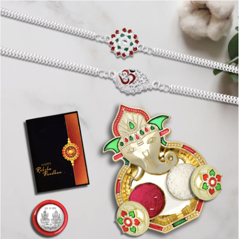 Silver Rakhi Set with Ganesha Tilak Thali – 2 Designer Rakhis, Coin & Chocolate Gift Combo